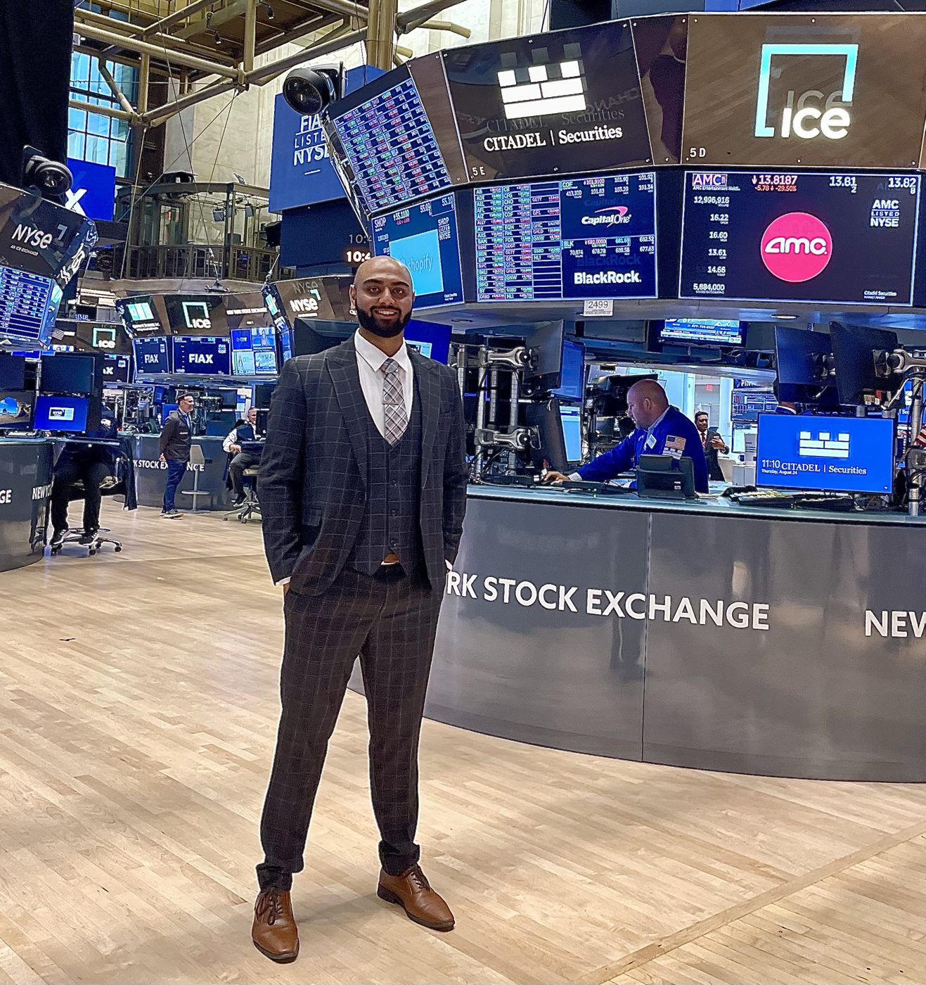 Mehul Patel in a three-piece suit on the New York Stock Exchange trading floor
